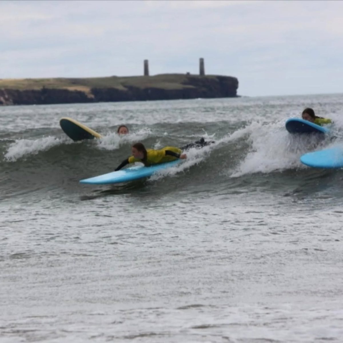 Surfers taking a lesson with Freedom Surf School on Tramore Beach in County Waterford