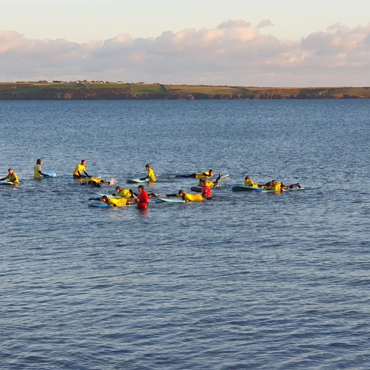 Surfers taking a lesson with Freedom Surf School on Tramore Beach in County Waterford