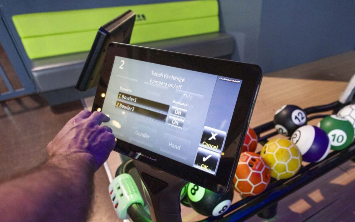 Touchscreen bowling console and colourful bowling balls at Activate Waterford