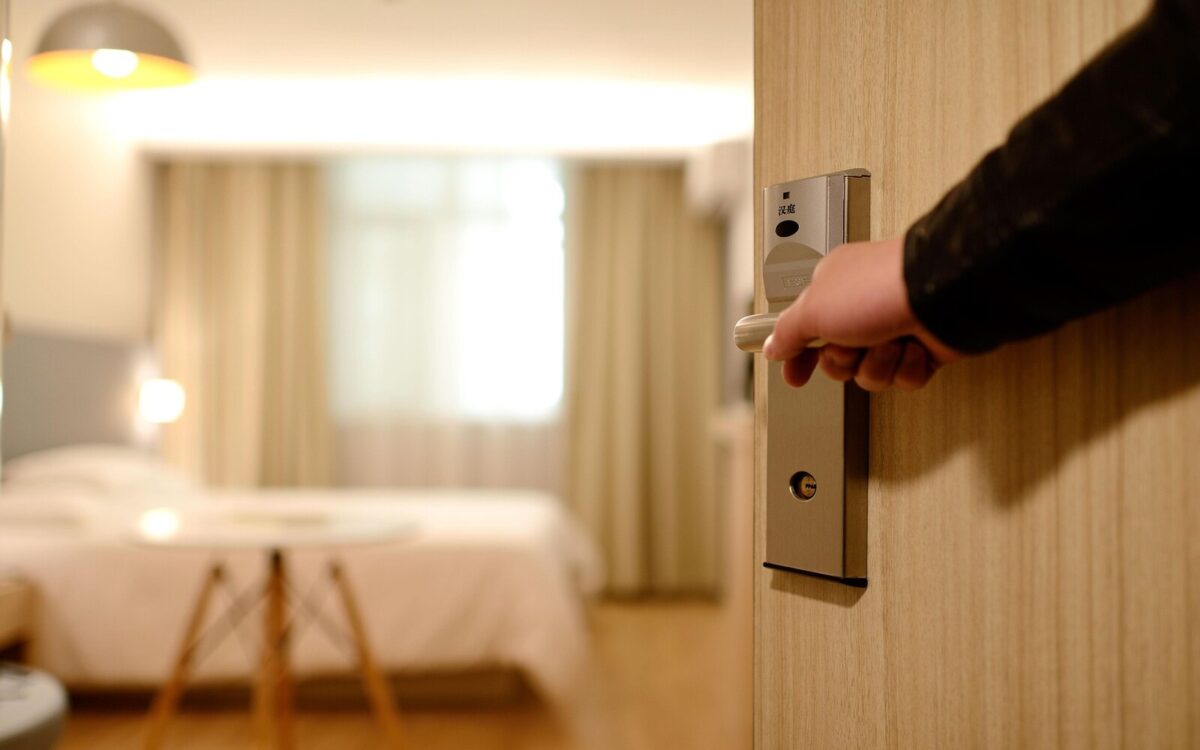 Guest opening the door to a hotel room