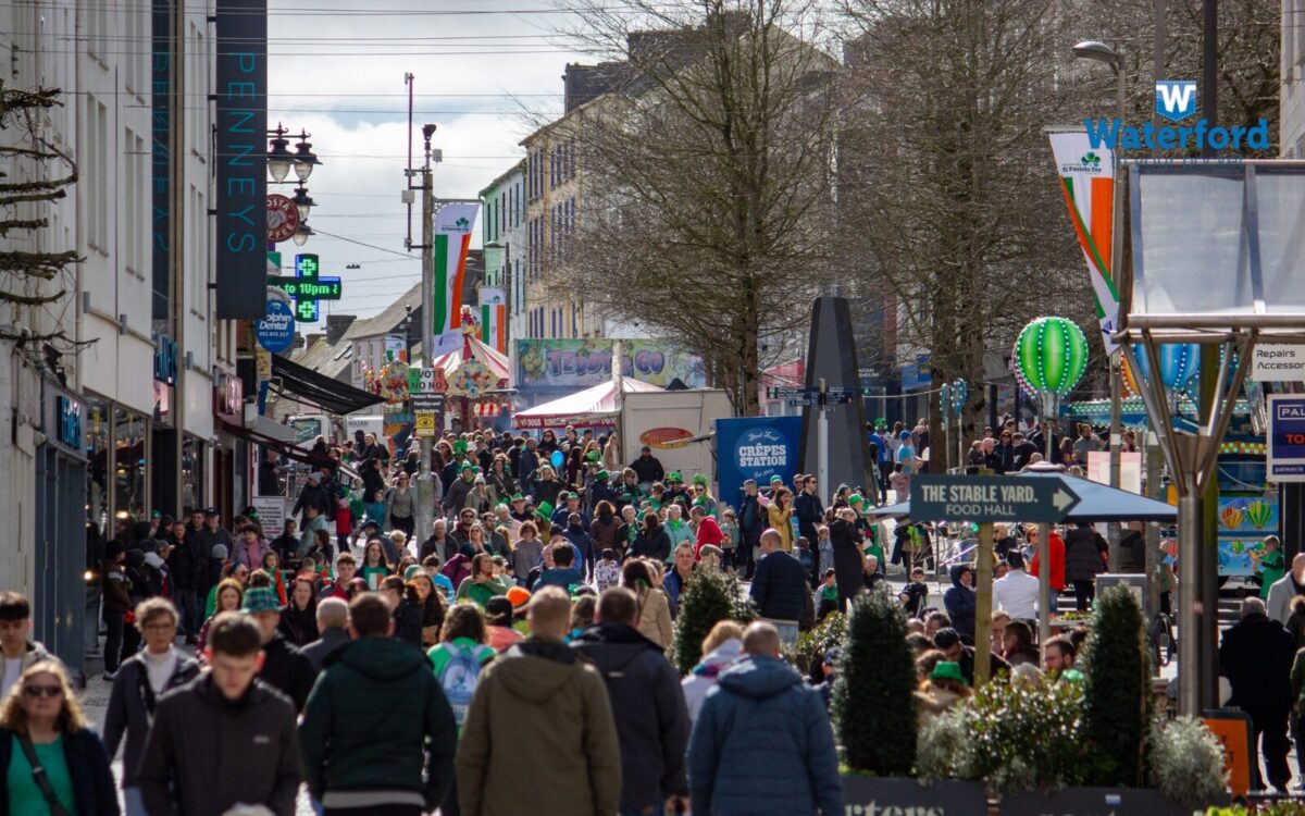 Shoppers and stalls on a busy shopping street in Waterford city